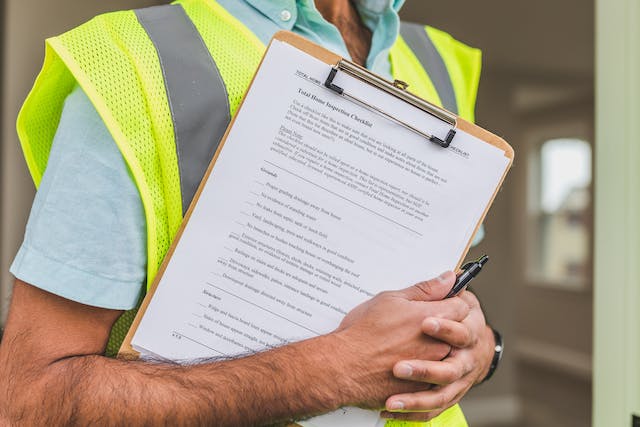 An inspector holding a home inspection checklist.