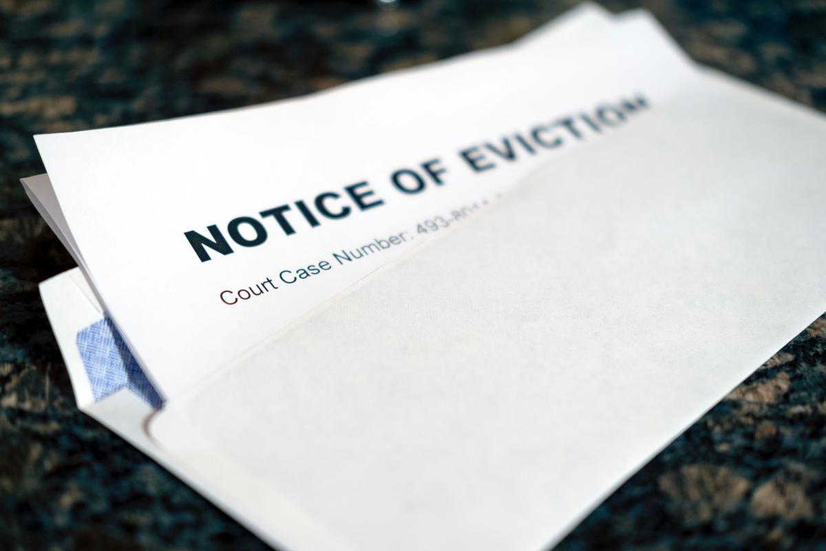 A realistic image depicting a landlord reviewing legal documents related to rent collection after eviction