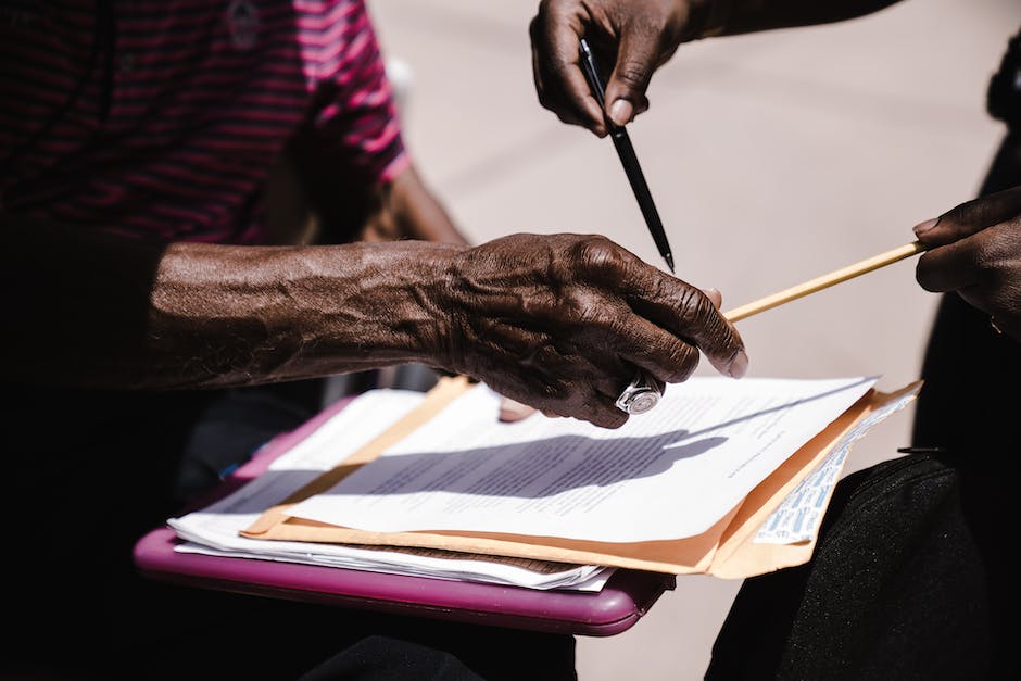 A person holding a contract with a pen, symbolizing the end of an existing contract.