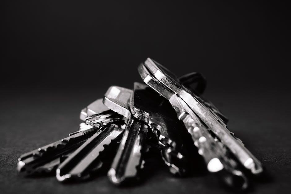 A person holding keys and a house, representing property management.