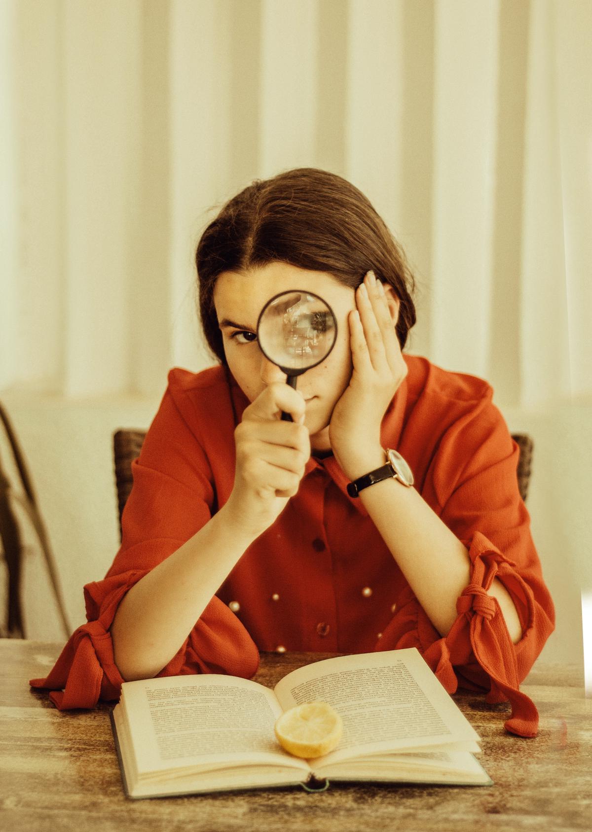 Illustration depicting a person reading a document with a magnifying glass, representing the importance of understanding the HOA rules.